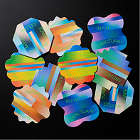 Holographic stickers with wavy edges on black