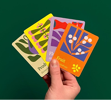 A hand fanning illustrated botanical cards
