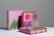 Gift boxes with pink and green geometric artwork